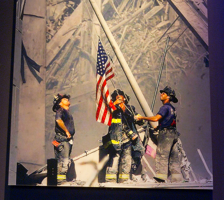 FDNY Three firefighters raise the American flag in the afternoon on the pile of wreckage of the World Trade Center, now Ground Zero. Dan McWilliams, George Johnson, Ladder 157, and Billy Eisengrein, Rescue 2 by Thomas E Franklin. Photo on view in 9/11 Memorial Museum. 