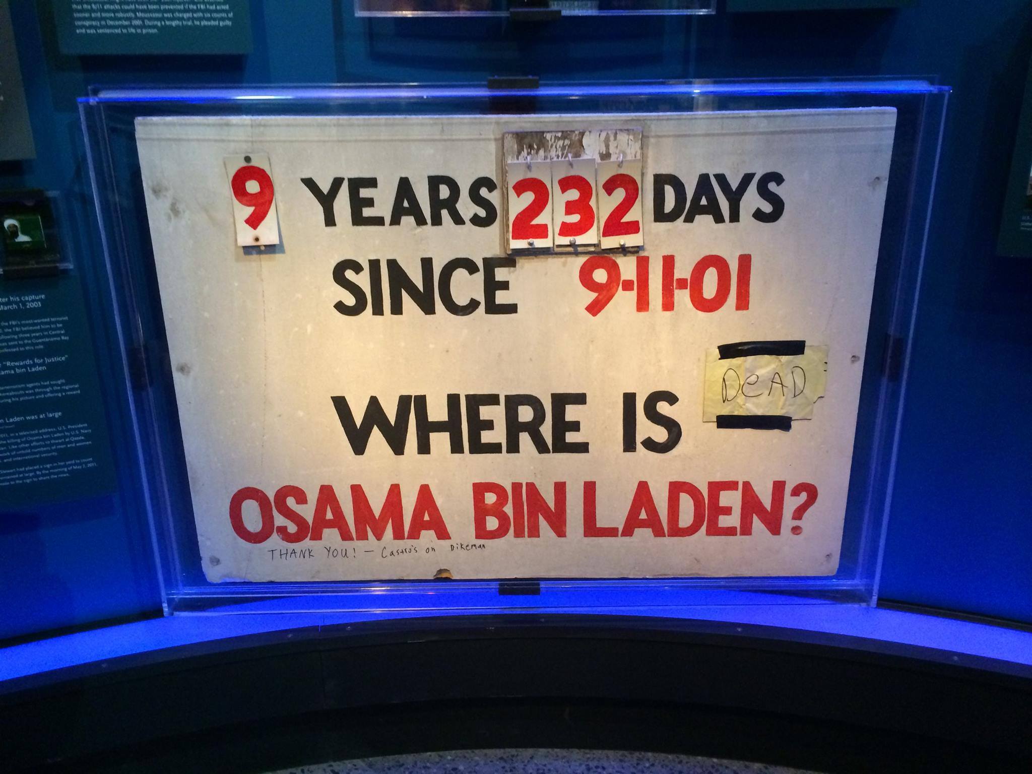 A homemade sign displayed at the Museum counts the number of days since 9/11. The sign also reads, “Where is Osama bin Laden?” A handwritten not taped next to the question reads, “Dead.”