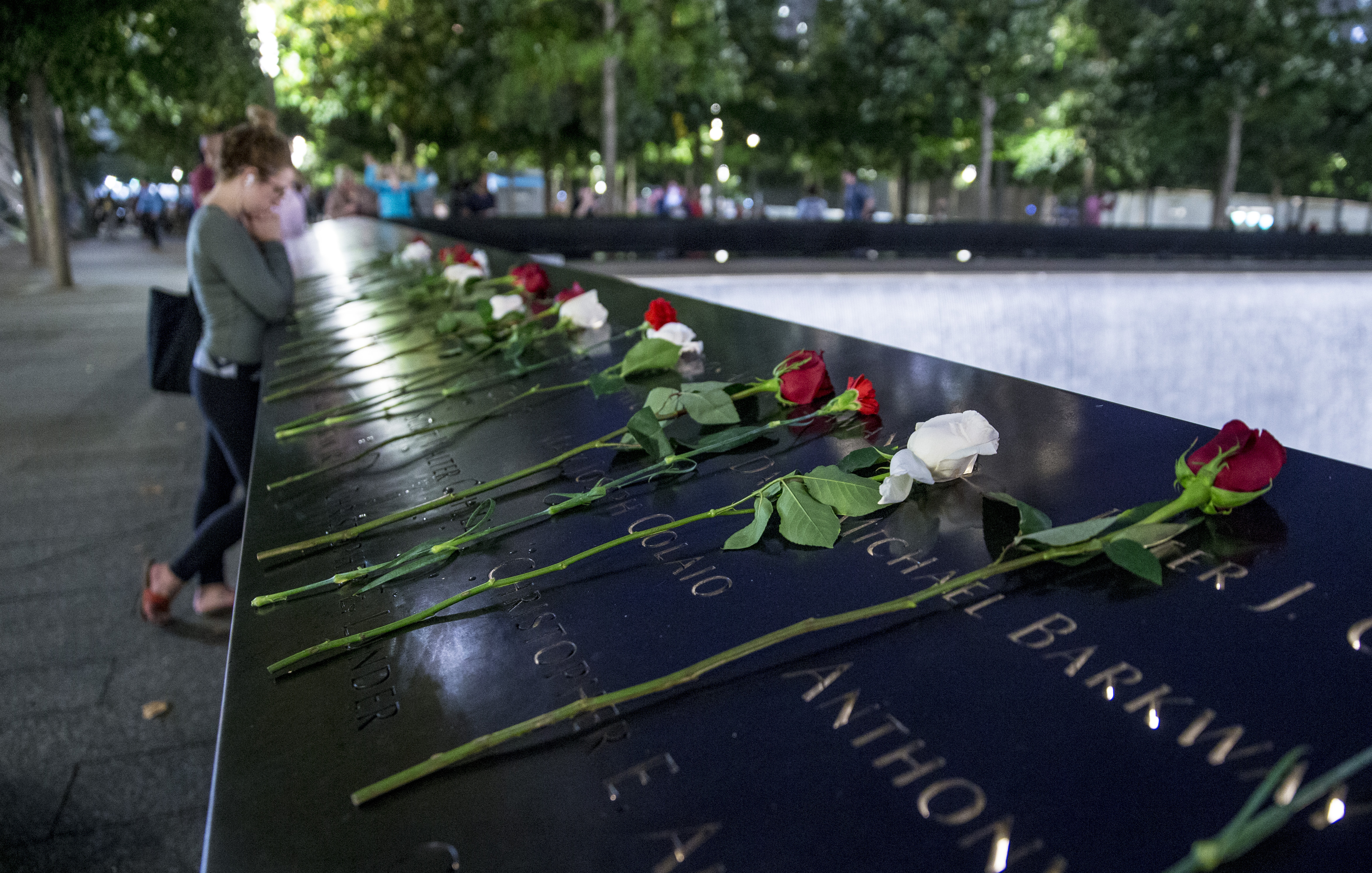 Red and white roses have been left on the bronze parapets at the 9/11 Memorial.