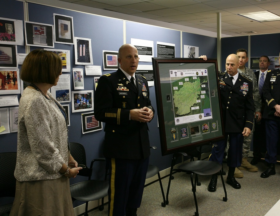 Colonel Mark Mitchell presents a map showing the location of buried World Trade Center steel in Afghanistan. 9/11 Memorial Museum Director Alice Greenwald stands beside him.
