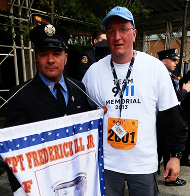 Michael Trofinoff stands beside a member of the FDNY as they pose for a photo at a Tunnel to Towers 5K event.