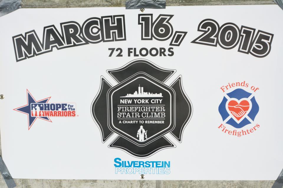 A poster from the first annual NYC Firefighter Stair Climb is displayed in March 2015. The logo of the climb is a firefighter shield with the New York City skyline.
