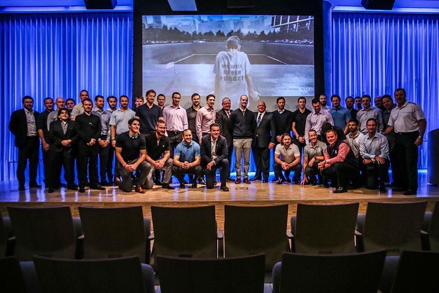 The New York Rangers pose for a photo onstage at the 9/11 Memorial Museum’s Auditorium.