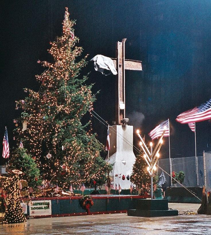 A Christmas tree, a menorah and the "World Trade Center cross" are displayed at Ground Zero in December 2001.