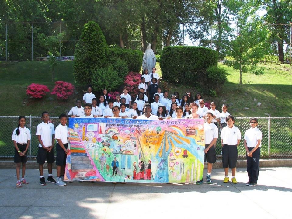Students from the Immaculate Conception School Aquinas Honor Society and Principal Dori Breen show the tribute mural given to them by the 9/11 Memorial Museum.