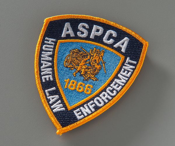 ASPCA embroidered uniform patch depicting the image of a horse and cart in the center. Collection 9/11 Memorial Museum, gift of the Diane DiGiacomo family. Photo by Michael Hnatov.
