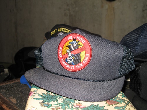 Black baseball cap with red patch on front, "FBI-NYPD/JOINT TERRORIST TASK FORCE." Donated by Charles Maikish.