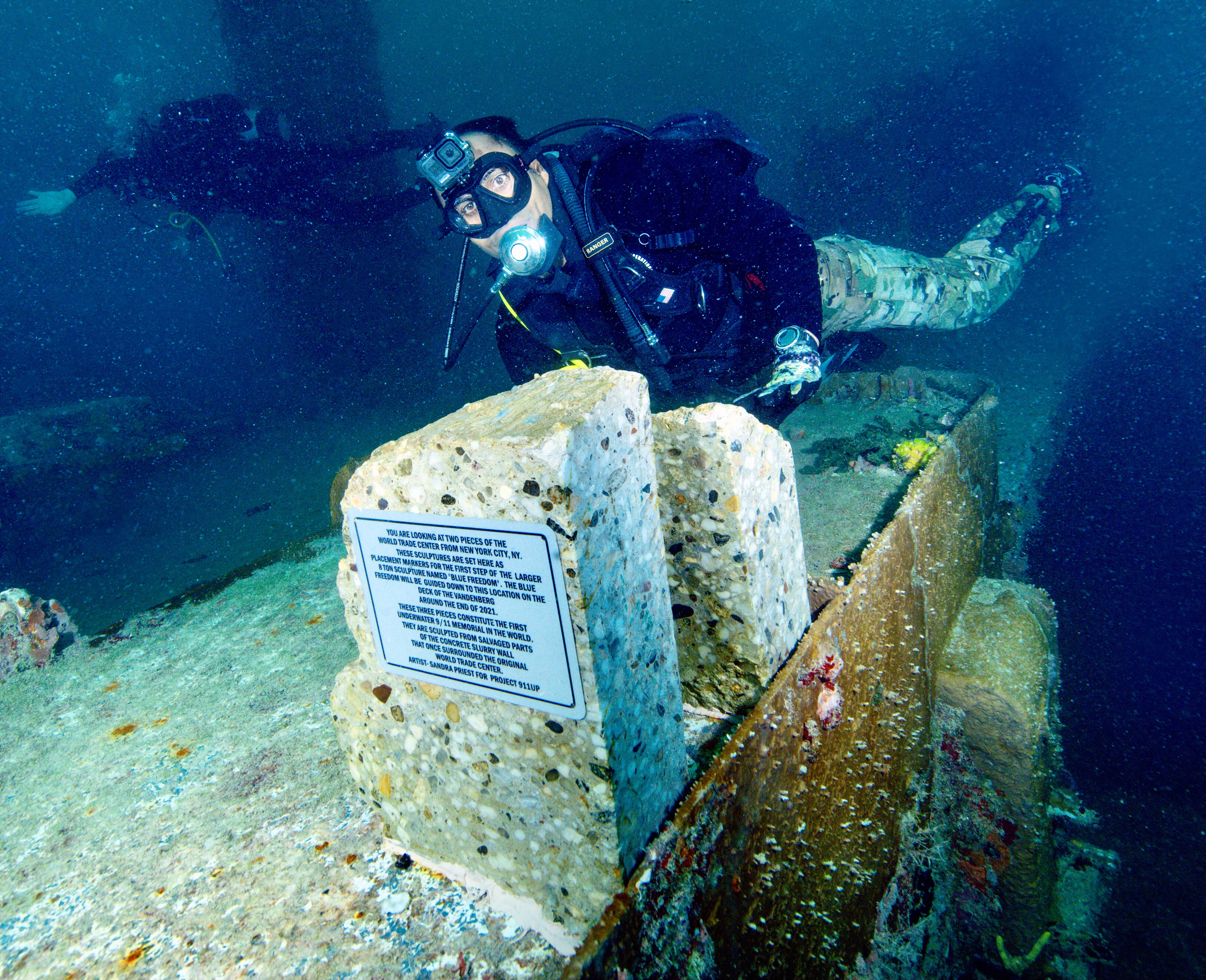 This is a photo of a Navy Seal right after the BLUE FREEDOM DUO of sculptures were permanently adhered to the deck of the US Vandenberg sunken ship now as an artificial reef.