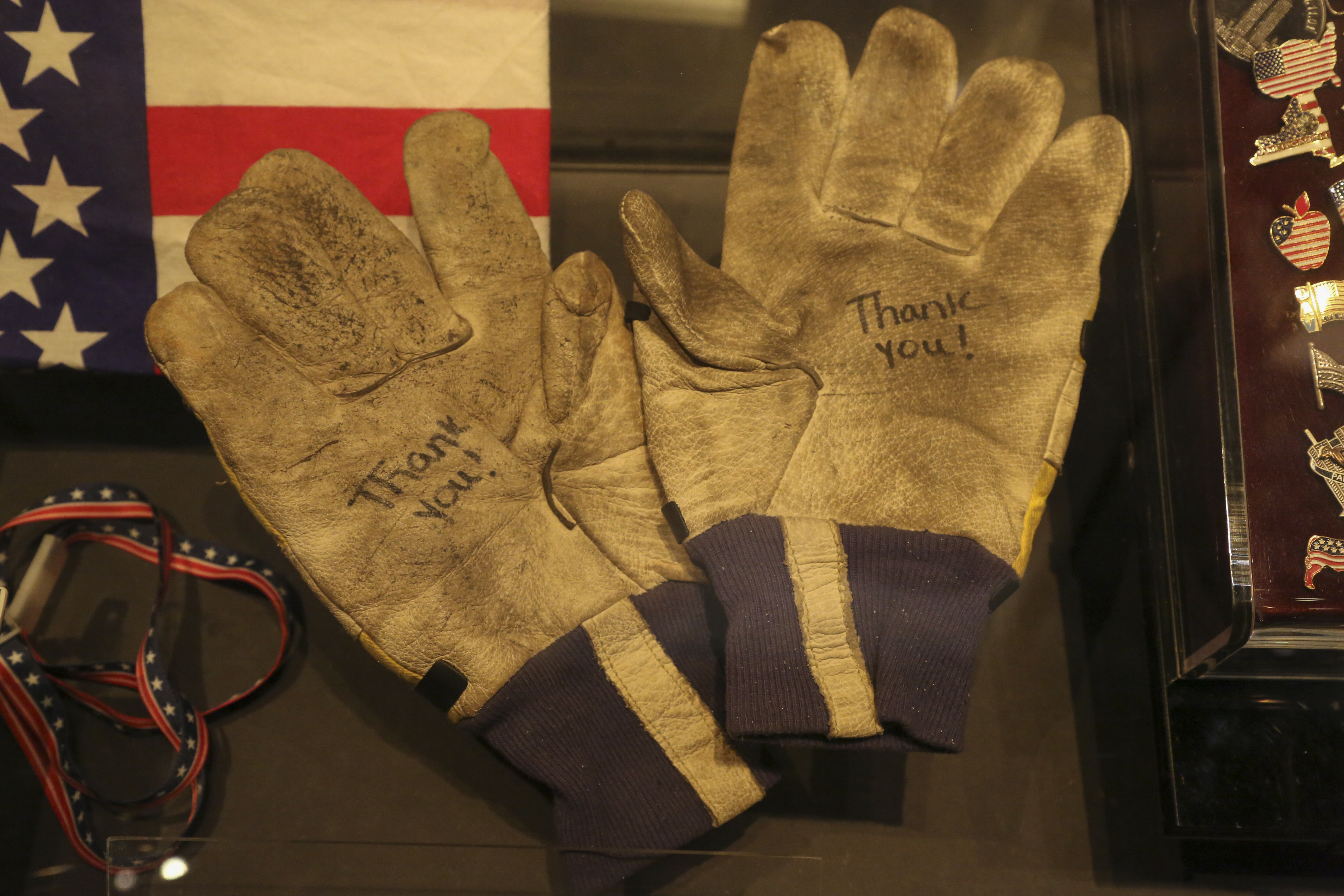 Two gloves belonging to NYPD officer David Brink are displayed at the Museum. The works “Thank You” have been written on both gloves in marker.