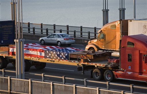 A-steel-beam-salvaged-from-the-World-Trade-Center-is-transported-across-the-George-Washington-Bridge-in-New-York-on-its-way-to-Coatesville-Penn.-Wednesday-April-14-2010.-A-mile-long-convoy-of-28-tractor-traile.jpg