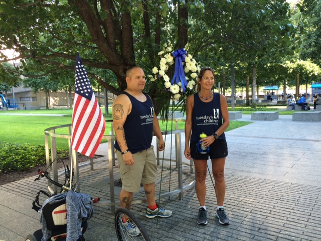 Eva Casale and Michael Roesch pose beside the Survivor Tree at the 9/11 Memorial.