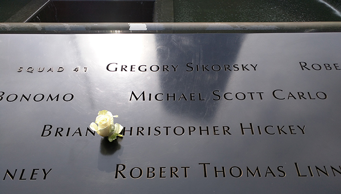 A white rose has been placed at the name of Brian Christopher Hickey at the 9/11 Memorial.