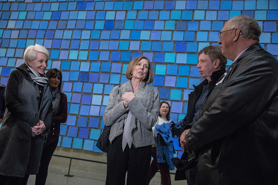 9/11 Memorial & Museum President Alice Greenwald greets Gander residents during their visit to the 9/11 Memorial Museum. Greenwald and the four visitors are standing in front of artist Spencer Finch’s installation, “Trying to Remember the Color of the Sky on That September Morning.”