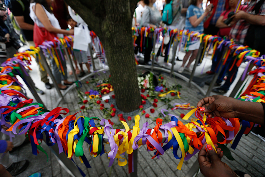 Ribbons of various colors form a rainbow ring around the Survivor Tree. The ribbons have been tied on a railing around the tree to honor victims of the Pulse nightclub shooting in Orlando, Florida.