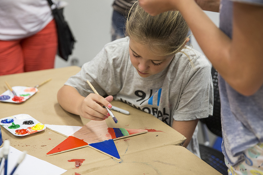 A young girl paints stars of hope for victims of Orlando as part of a project at the Museum.