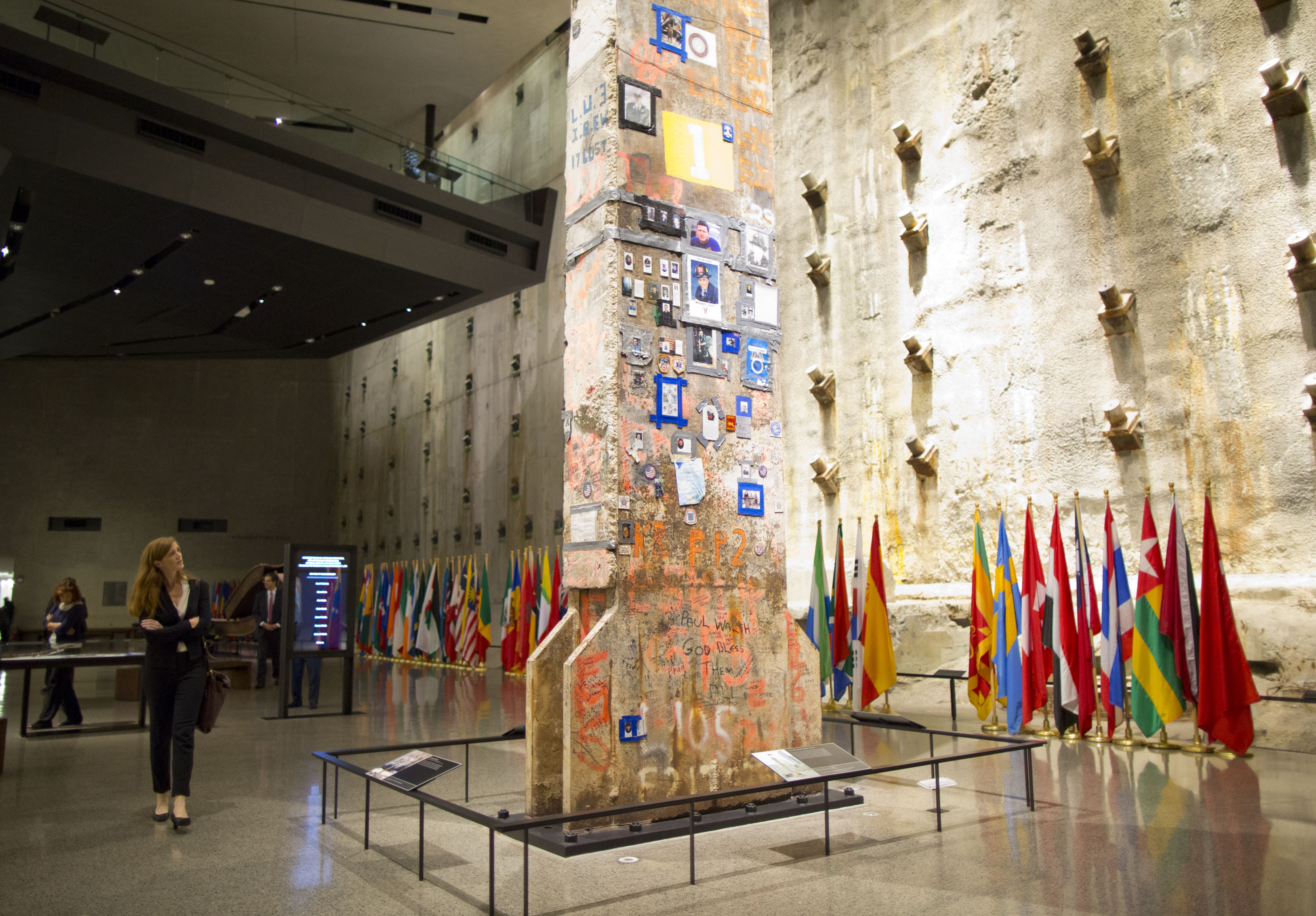 U.S. permanent representative to the United Nations, Samantha Power, views the Last Column in the Museum. Surrounding her are flags to honor the individuals from more than 90 countries who died on 9/11.