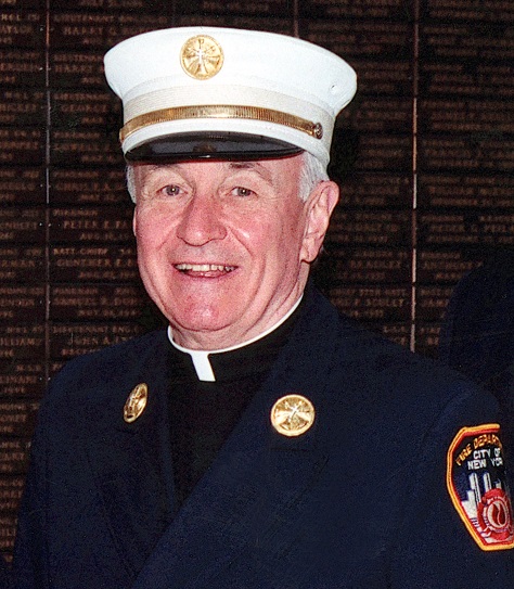 Father Mychal Judge, an FDNY chaplain, smiles for a photo in a formal FDNY outfit.