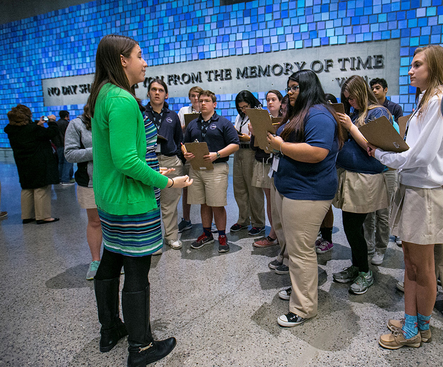 A Museum employee speaks to a group of students in front of artist Spencer Finch’s installation, “Trying to Remember the Color of the Sky on That September Morning.”