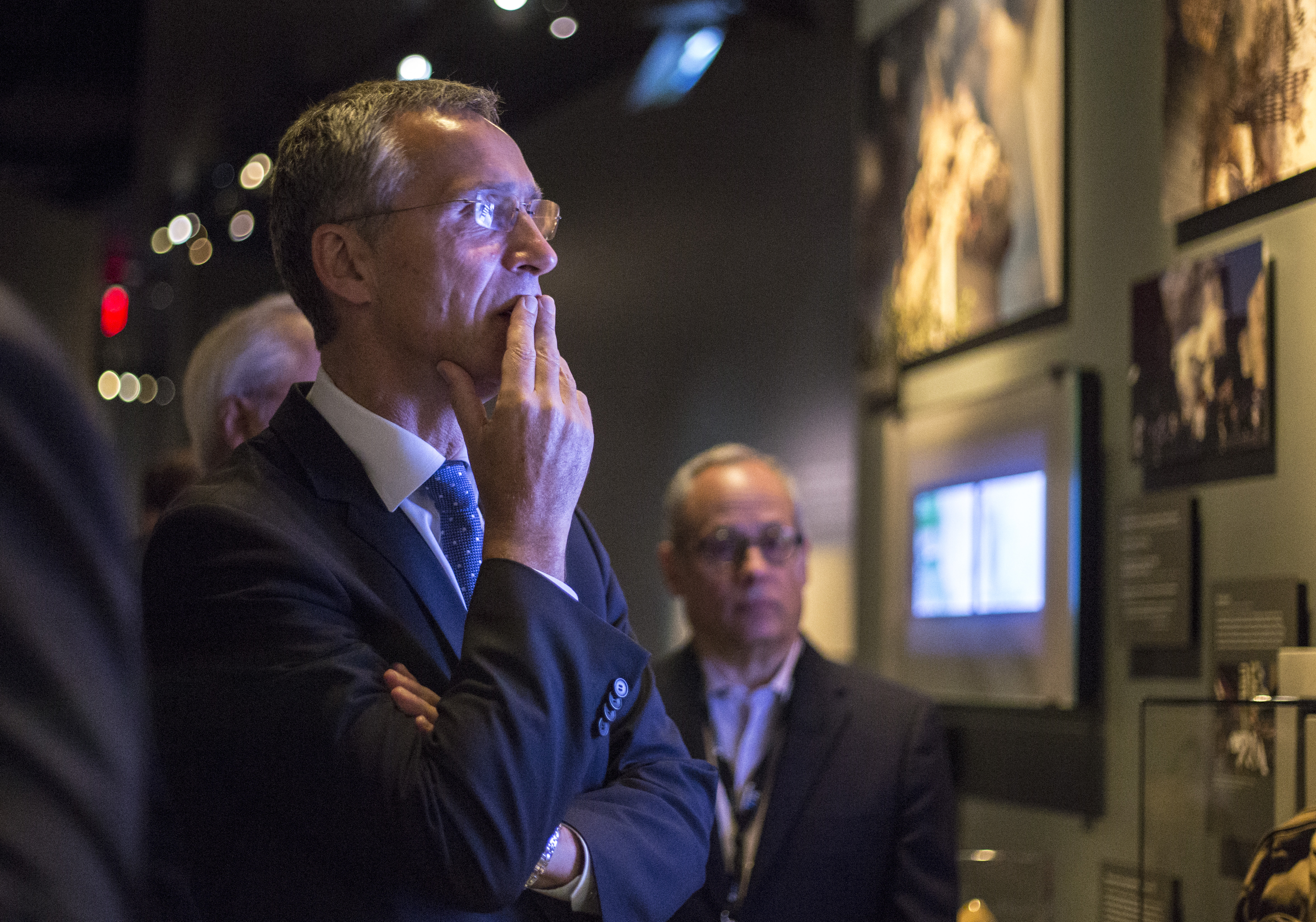 NATO Secretary General Jens Stoltenberg puts his hand to his mouth as he looks at an installation at the 9/11 Memorial Museum.