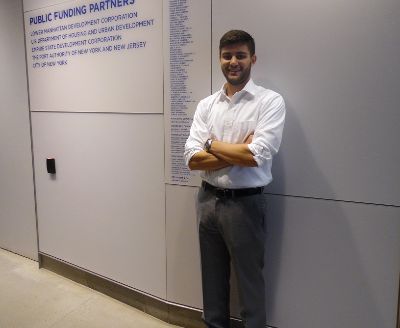 John Andelfinger, a 9/11 Memorial events intern, poses for a photo in a hallway of the 9/11 Memorial Museum.