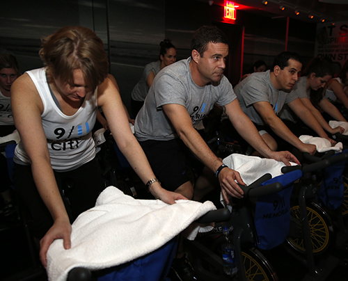 9/11 Memorial President Joe Daniels and other participants ride stationary bikes at the Ride to Remember charity event.