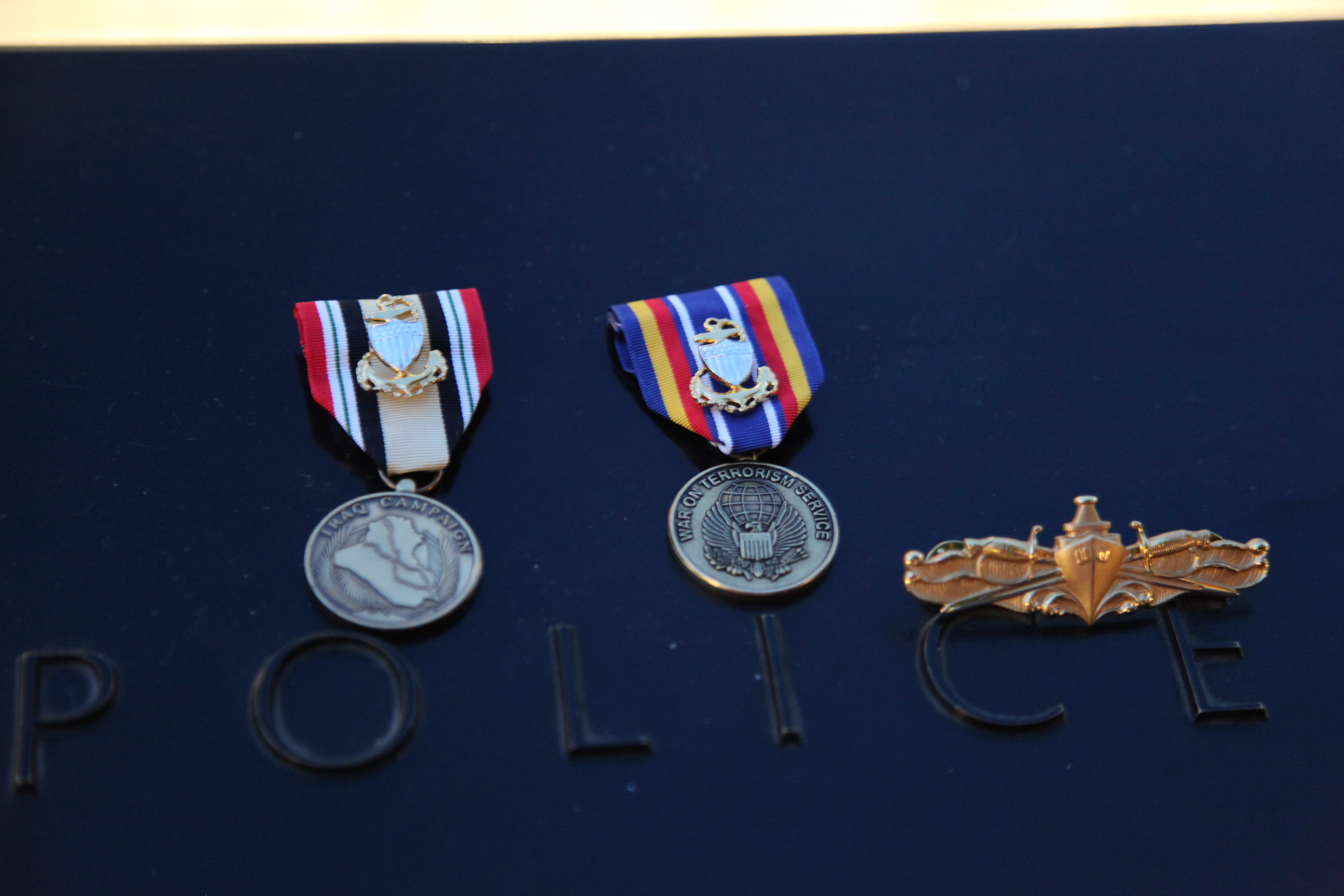 Three medals have been placed on a bronze parapet at the Memorial. The medals have been placed at a label reading “police.”