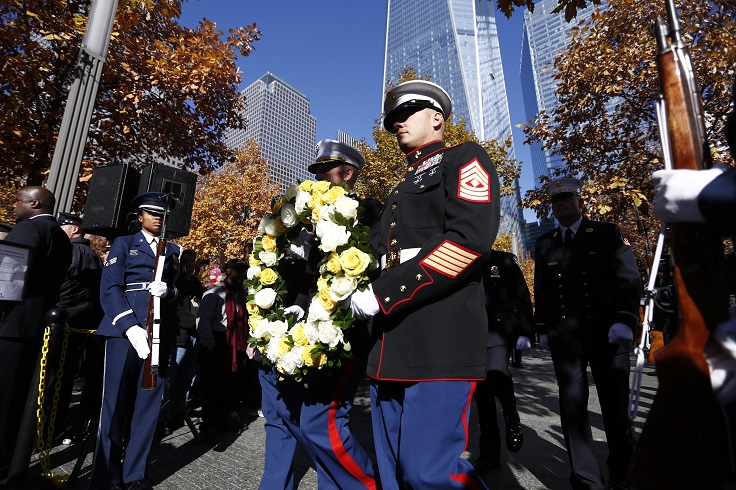 Members of the United States military place a wreath at the Survivor Tree on the 9/11 Memorial plaza during the 2014 Salute to Service.