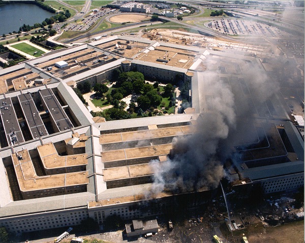 An aerial view of the entire Pentagon on 9/11 shows black and gray smoke rising from a large hole in the building.