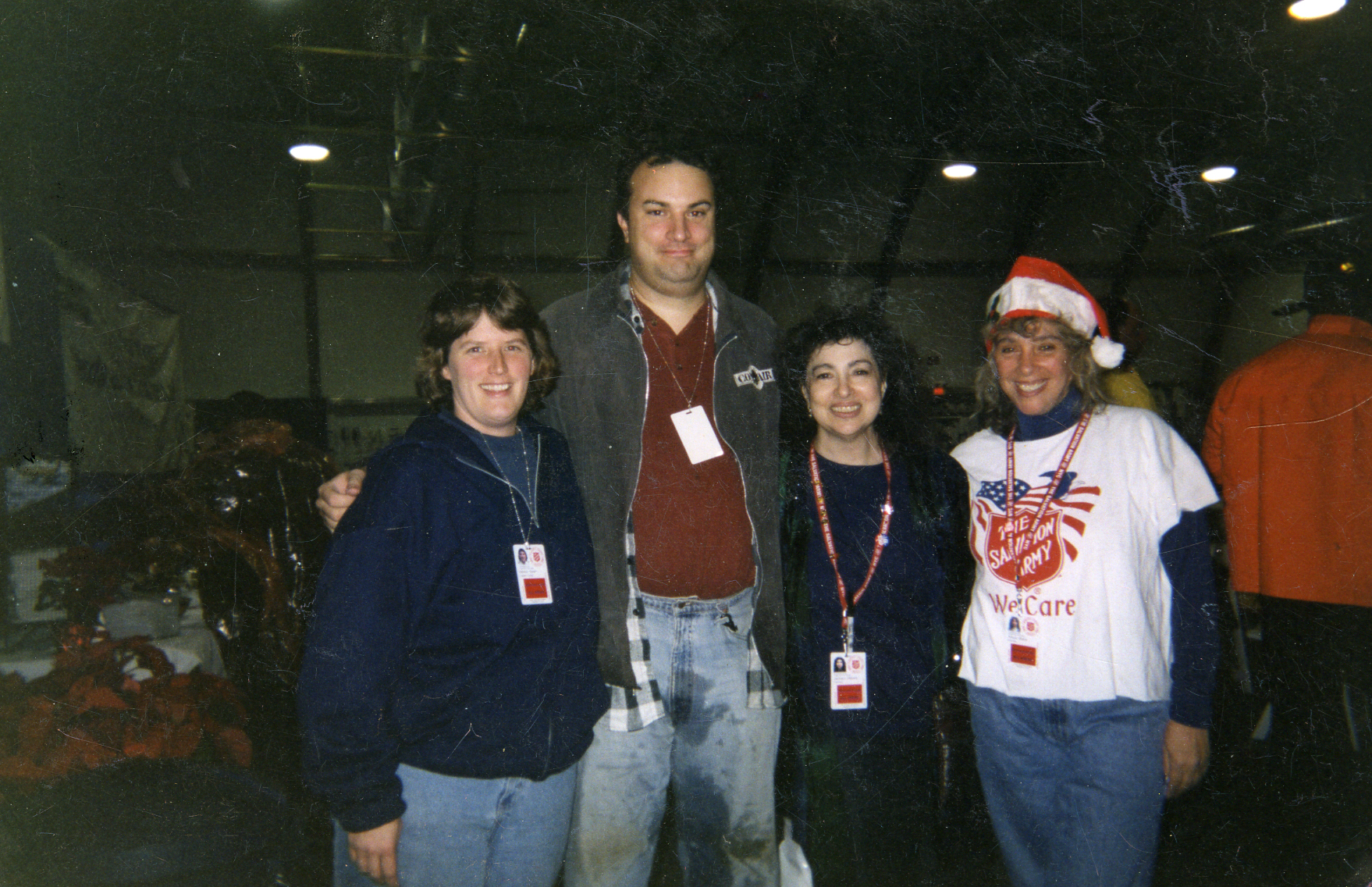 Four Salvation Army volunteers—three women and a man—pose for a photo together at the Salvation Army tent near Ground Zero in December 2001.
