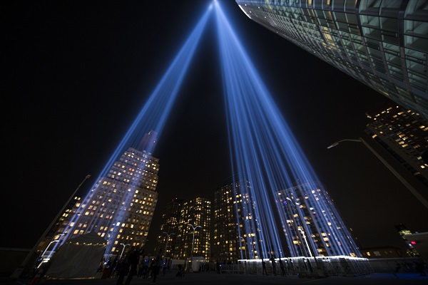 The twin beams of light from the Tribute in Light rise high above lower Manhattan and towards the night sky in this image taken near the base of the lights.