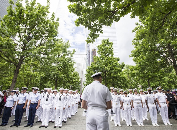 Formally dressed members of the Navy stand at attention on the Memorial plaza.