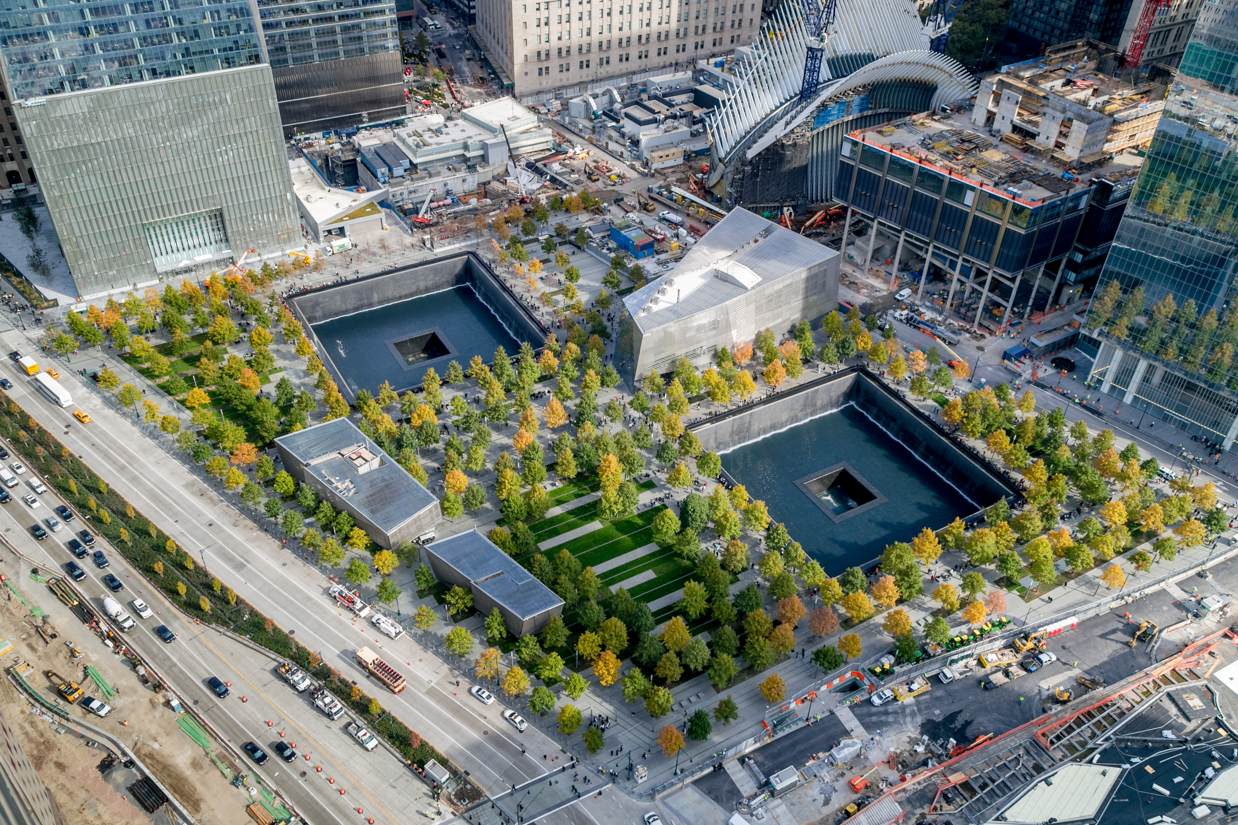This autumn aerial of the 9/11 Memorial plaza shows the twin reflecting pools, the Museum pavilion, and the dozens of colorful swamp white oak trees that fill the plaza.