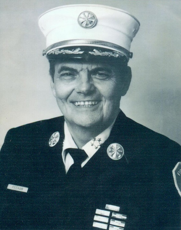 Chief William Feehan smiles wears a formal uniform as he smiles in this old black-and-white photo.