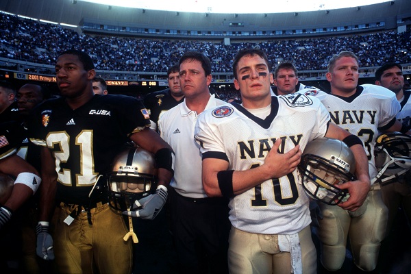 Members of the Army and Navy college football teams stand together for the U.S. National Anthem before their game on December 1, 2001.
