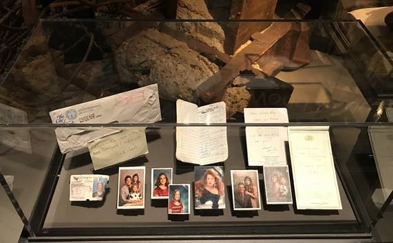An NYPD detective’s note and contents of a portfolio carried by Maynard S. Spence Jr. are shown on display in the Historical Exhibition. The portfolio includes notes and family photos.
