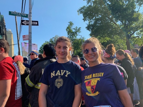 Trisha Franckowiak and her daughter Angelina Roffo pose for a photo amid a crowd of people at the annual Tunnel to Towers run.