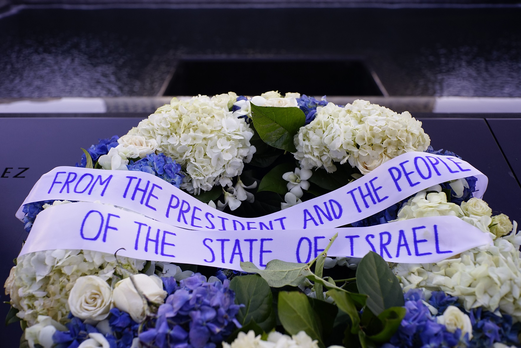 A wreath left at the 9/11 Memorial by Israeli President Reuven Rivlin includes white and blue flowers and the message “From the president and the people of the state of Israel.”