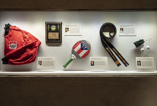 A Marlboro racing jacket, a paddleball paddle, a karate black belt, and two golf balls are among the items displayed at the “In Memoriam” gallery. Each item belonged to a victim of the 9/11 attacks.