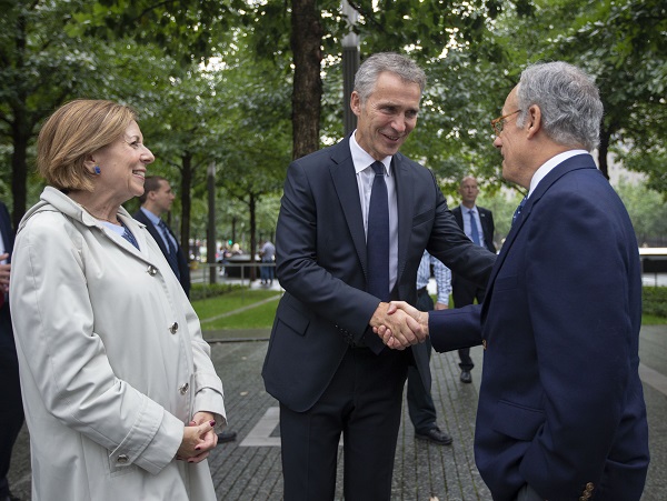 NATO Secretary General Jens Stoltenberg shakes hands with Clifford Chanini, the executive vice president and deputy director for museum programs. 9/11 Memorial President and CEO Alice Greenwald stands beside them.