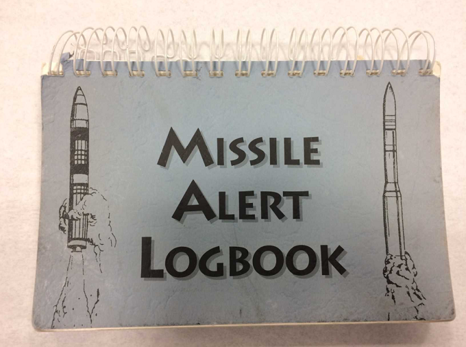 United States Air Force Lt. Col. Brande H. Walton’s logbook is displayed at the Museum. The gray, spiral-binded notebook features sketches of two missiles on its cover alongside the words “Missile Alert Logbook.”