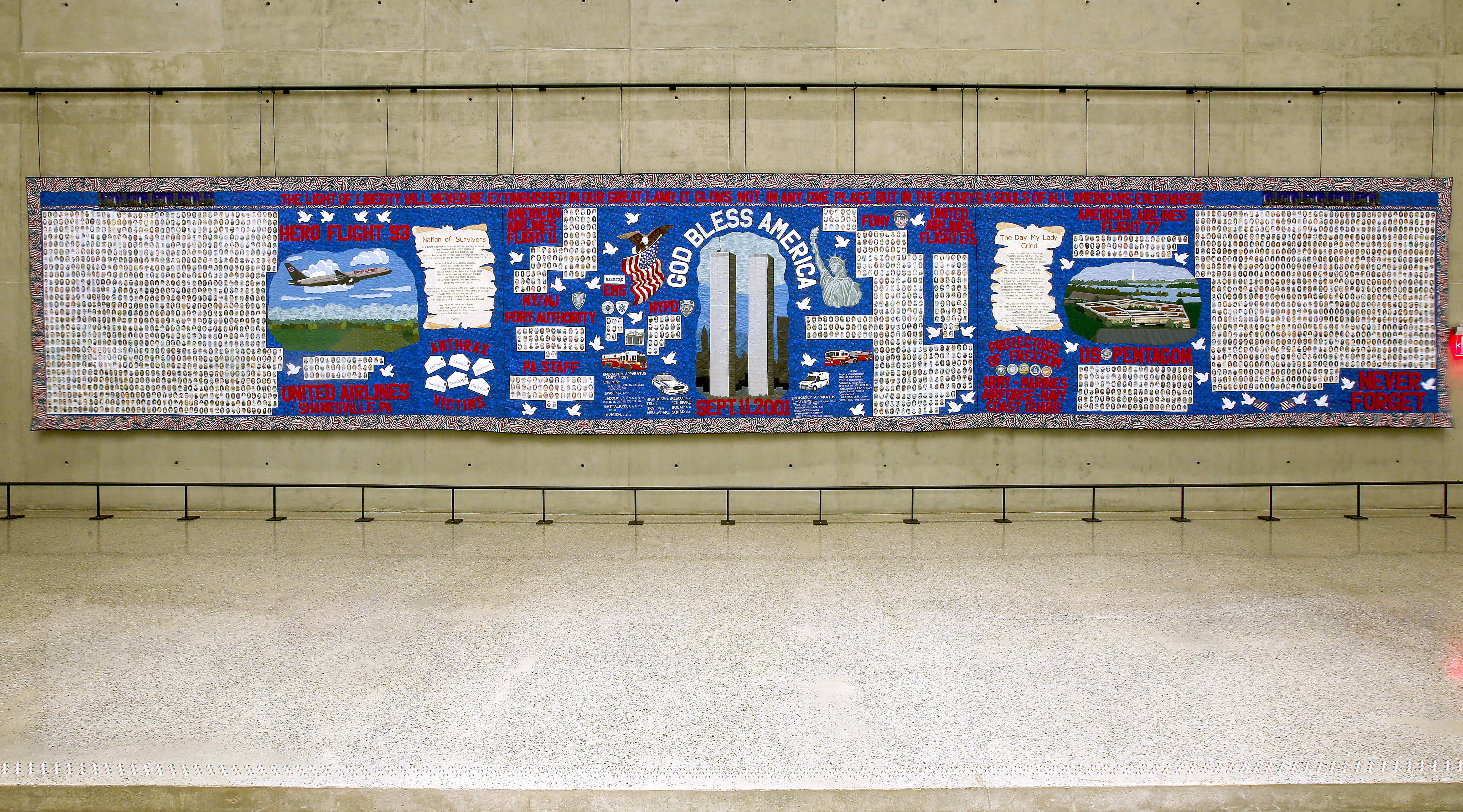 A 60-foot-wide quilt titled America’s 9/11 Victims Quilty is displayed at the Museum. The quilt features a latticework of pictures and names honoring the victims of the attacks. The center of the quilt includes a depiction of the Twin Towers with the words “God Bless America.”