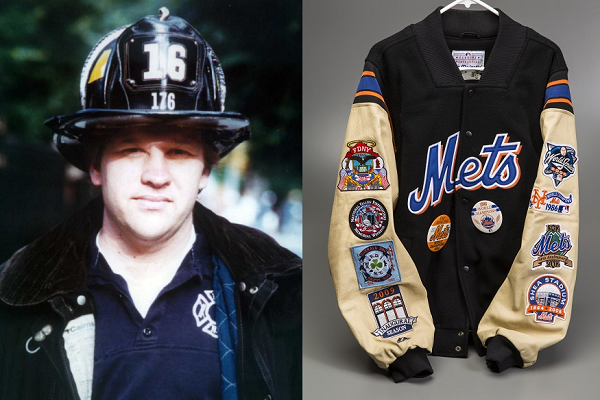 FDNY Lieutenant Kenneth John Phelan Sr. is seen in an old photograph. His black and white Mets jacket displayed on a gray surface. The jacket is filled with Mets and FDNY–themed patches.