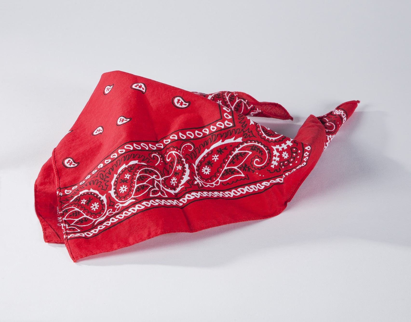 The red bandana belonging to 9/11 victim Welles Crowther is displayed on a white surface at the Museum.