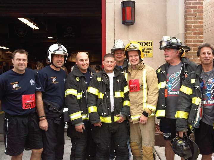 Derek McInnes and other members of the FDNY pose outside a firehouse in their bunker gear.