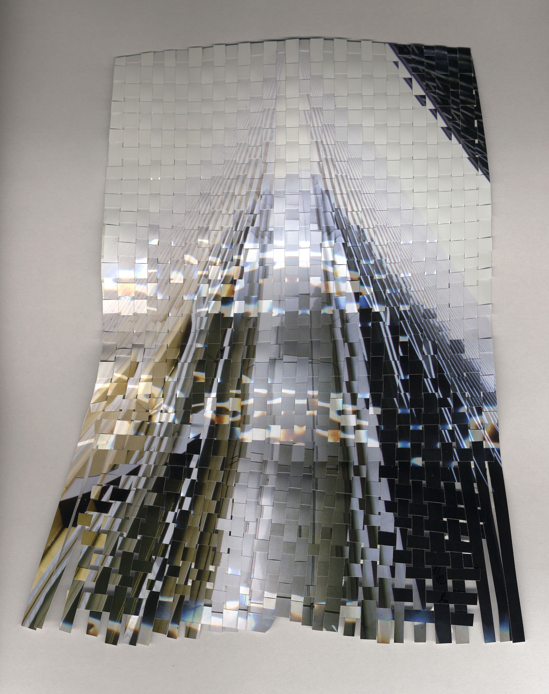 This artwork is made in 2000. A photography of the WTC from 1985 cut in stripes and woven later in 2024 formed into the sculpture with performance. please see the art shortfilm on the website.