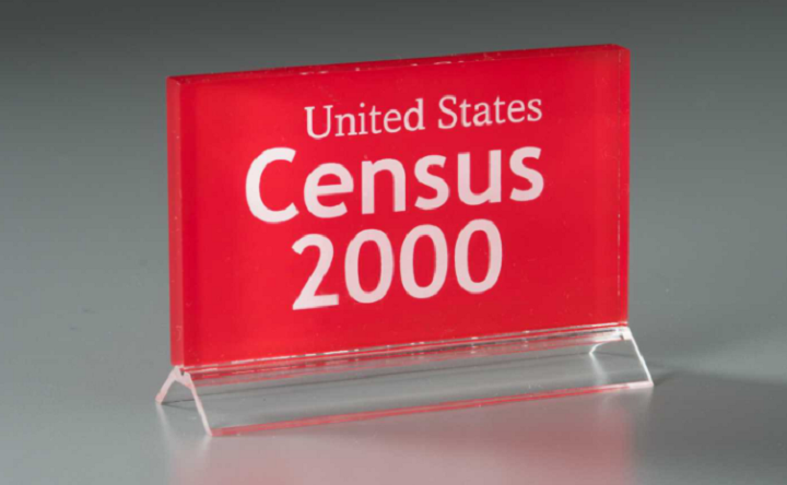 In front of a gray background, a red and clear lucite plaque reads "United States Census 2000."