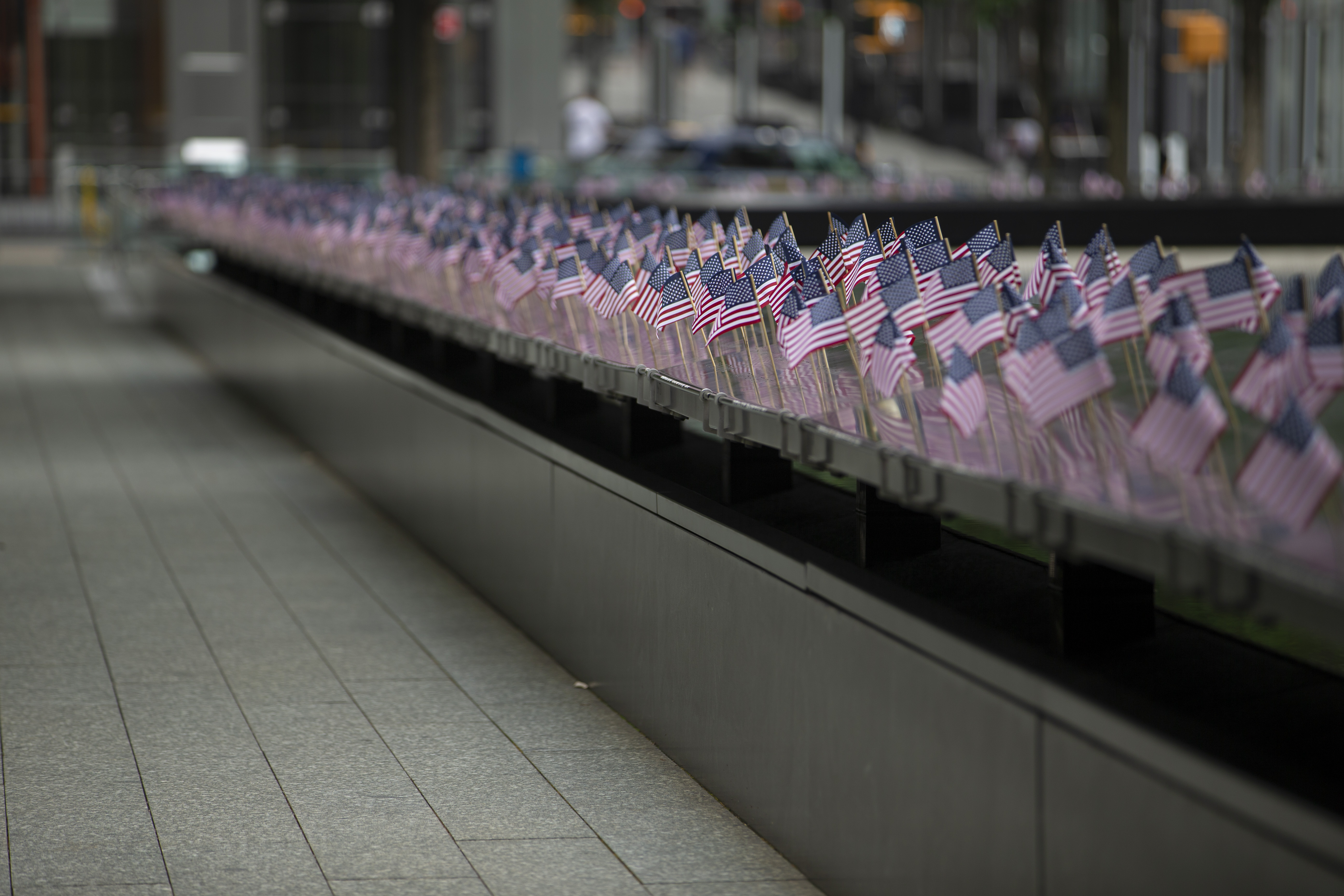 Small American flags line names along the Memorial 