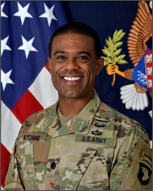 A smiling man in an Army camouflage uniform