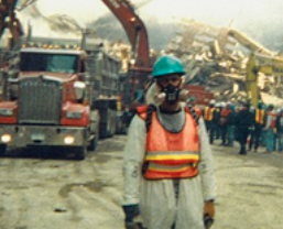 John Paluska at Ground Zero, in gas mask, neon safety vest, and hard hat