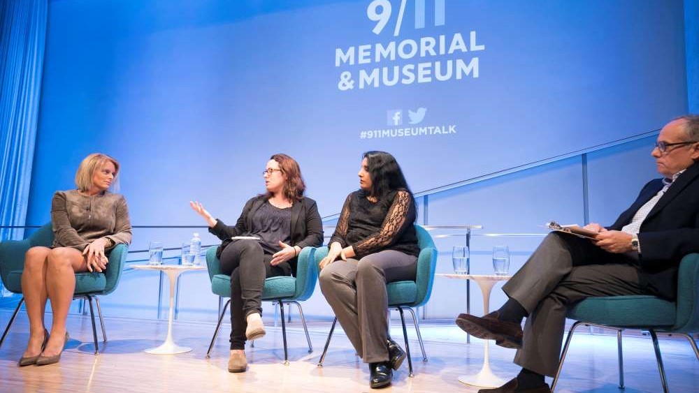 NY1 anchor Kristen Shaughnessy, New York Times correspondent and CNN analyst Maggie Haberman, and Associated Press reporter Deepti Hajela are seen seated onstage at the Museum Auditorium. Haberman is speaking and gesturing as the other participants listen on. Clifford Chanin, the executive vice president and deputy director for museum programs is to their right, listening and holding a clipboard.